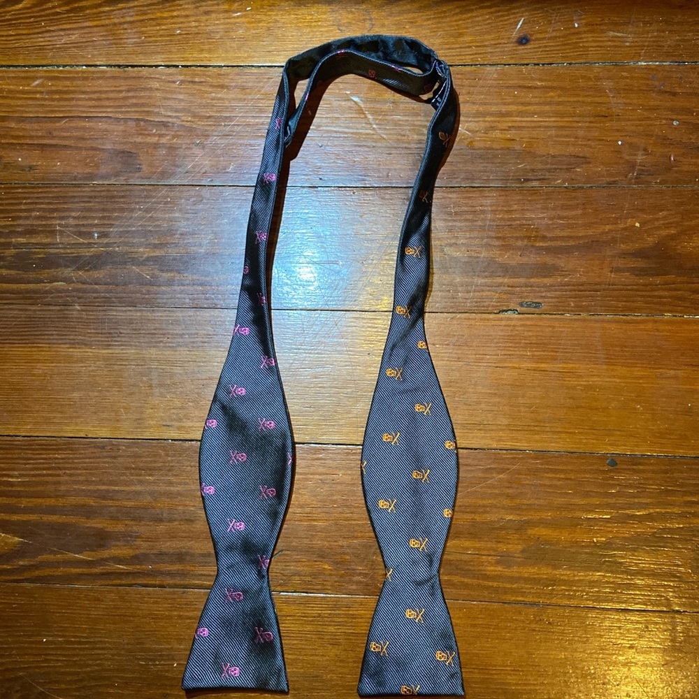 Gray bow tie with multi colored skulls